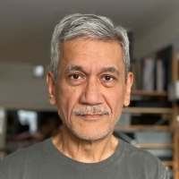portrait of man with mustache, wearing grey T-shirt