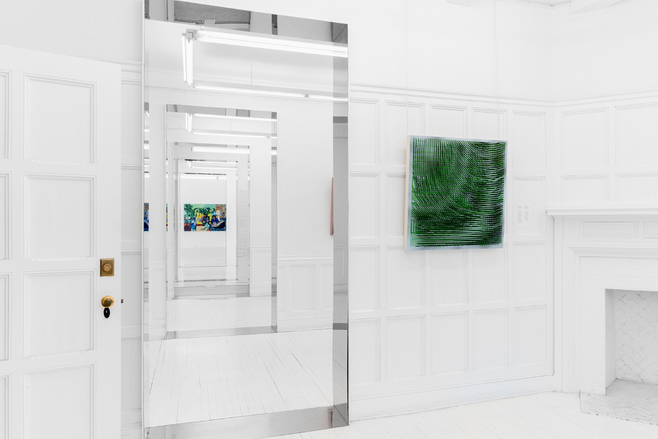 In an exhibition space, a square painting in the foreground and, at the  end of several rooms, a colorful painting