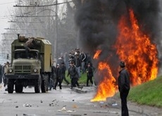 Kyrgyz opposition supporters attack a riot police vehicle during an anti government protest in Bishkek on April 7, 2010. Credit: Vyacheslav Oseledko, AFP, Getty Images