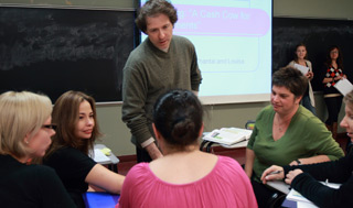 Robert Soroka confers with students (left to right) Nancy Gravel, Angela McIntyre, Anna Kanaras(back to camera) and Cynthia Buckley in the new complementary university credit businessprogram of the School of Extended Learning. | Photo by Andrew Dobrowolskyj
