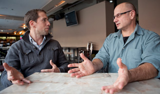 Marc Nisbet, of the University of the Streets Café, chats with theatre professor Ted LIttle. Little will lead a conversation at the Grande Biblothèque. | Photo by Concordia University