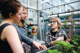 Ruby Jean Van Vliet (right) leads tours of the Henry F. Hall Building greenhouse as one of her many duties as communications officer there. She got involved through her problem-based service learning course last year. | All photos by Concordia University