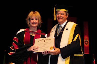Kathy Reichs, forensic anthropologist and author, receives an honorary doctorate from Chancellor L. Jacques Ménard at this year's fall convocation. | Photo by IPI