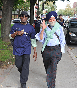 Dan Otchere, long-time Concordia economics associate professor (at left), with professor emeritus of economics Balbir Sahni at Shuffle 22 in 2011. Otchere says the walk between campuses symbolizes how the Shuffle brings together the university’s faculty, staff and students for a great cause. | Photo by Ryan Blau/PBL Photography