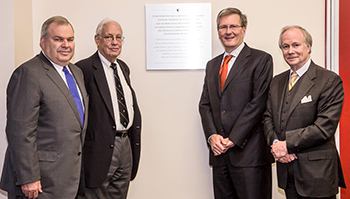 From left: J. Birks Bovaird, Evan Birks, Alan Shepard and Jonathan Birks unveil a plaque in the Webster Library on October 17 to honour the Birks family’s contributions to Concordia. | Photo by 