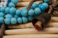 Woman's hair pipe necklace (detail). Anonymous. Northern Plains, Aboriginal, 1900-1910, 20th century. Glass beads, cow bone hair pipes, leather, cotton cloth, brass thimble. Gift of John L. Todd. © McCord Museum