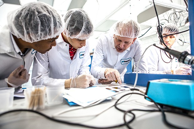 Rami Kandela and Ali Elawad examine solar cells with senior satellite designer Maarten Meerman