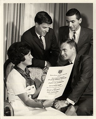 Joanne Fraser, John Keirstead, Harold Bedoukian, Jack Skene pictured with the scroll of the Charter to the Garnet Key Chapter of the Alumni Association.