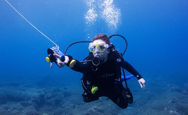 Mikayla Wujec scuba dives off the island of Molokaʻi, Kalaupapa National Historical Park, Hawaii