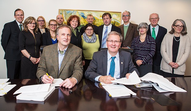 Concordia President Alan Shepard (right) and CUPFA President David Douglas sign the CUPFA collective agreement.