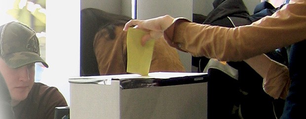 Voter using ballot box on campus