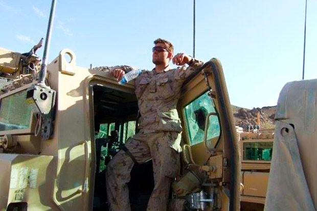 Leger takes a breather at the hatch of an armoured personnel carrier, before leaving on patrol in Afghanistan.