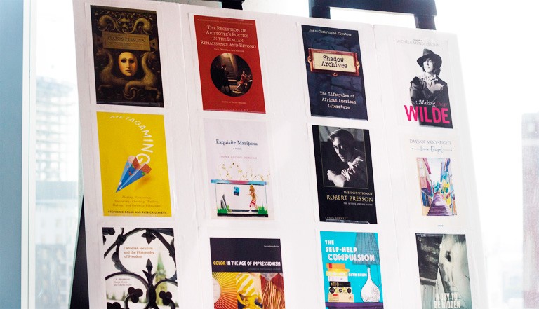 A poster showing books written by Liberal Arts College alumni.