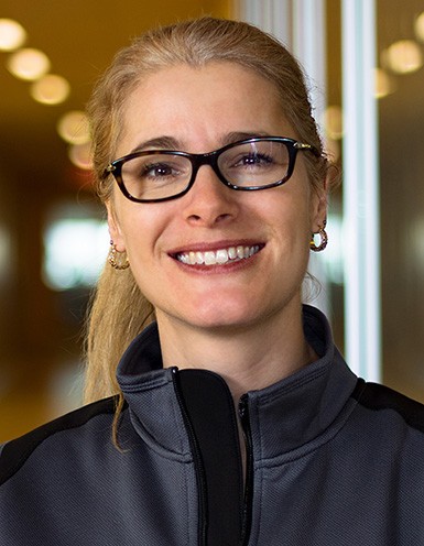 Young woman with blonde hair and glasses