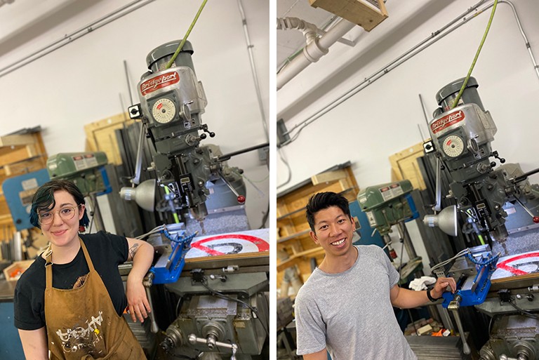 On the left, a young woman with glasses, overalls and short hair, standing in front of a printmaking press. On the right, a young asian man with short hair and a grey T-shirt, standing in front of a printmaking press.