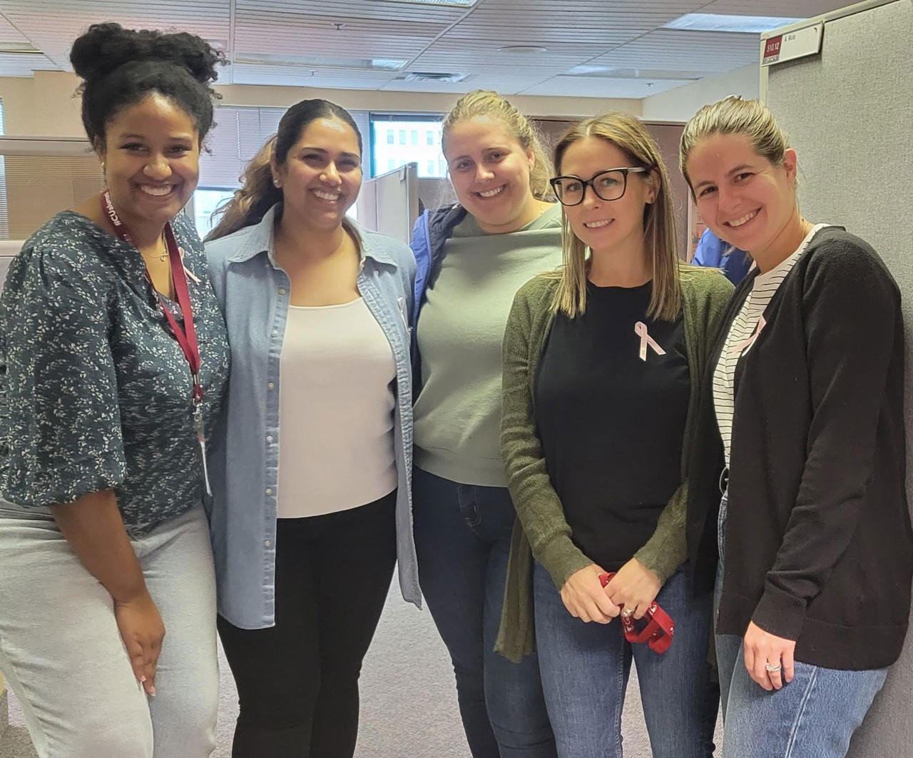 Alumni Engagement employees wearing pink ribbons and denim jeans