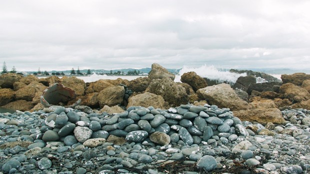 A pile of rocks along a shore 