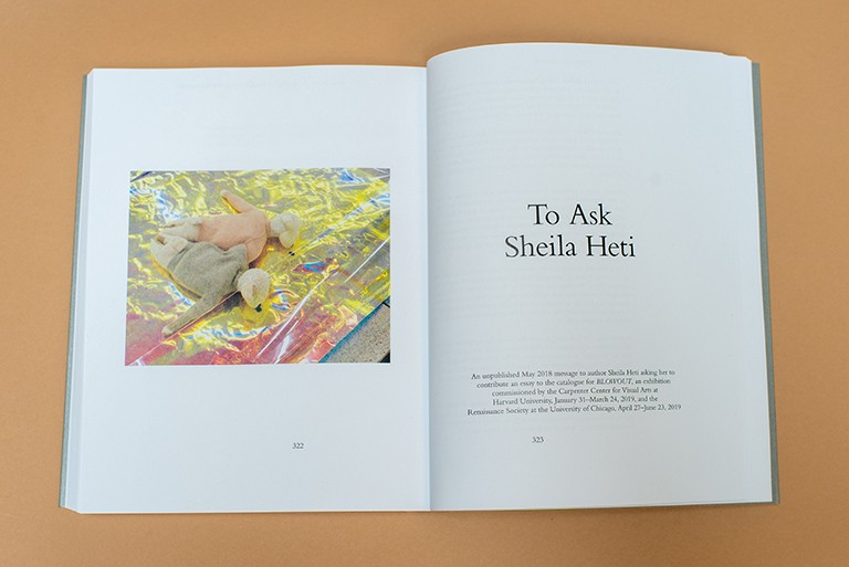 Photo of a double-page spread from a large hardcover book with images on one side and text on the other.
