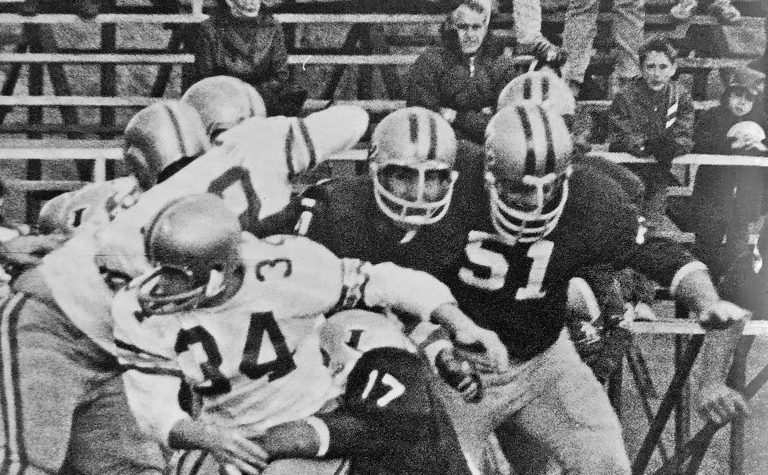 A black-and-white image of the Loyola College football team playing an opponent.