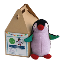 A colourful stuffed penguin sits next to a small cardboard box with handles
