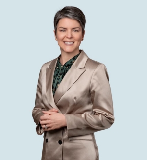 Image of a smiling, short-haired woman in a business suit.
