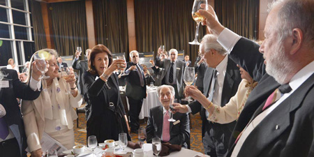 Glasses raised to Concordia President and Vice-Chancellor Frederick Lowy and Mary Kay Lowy.