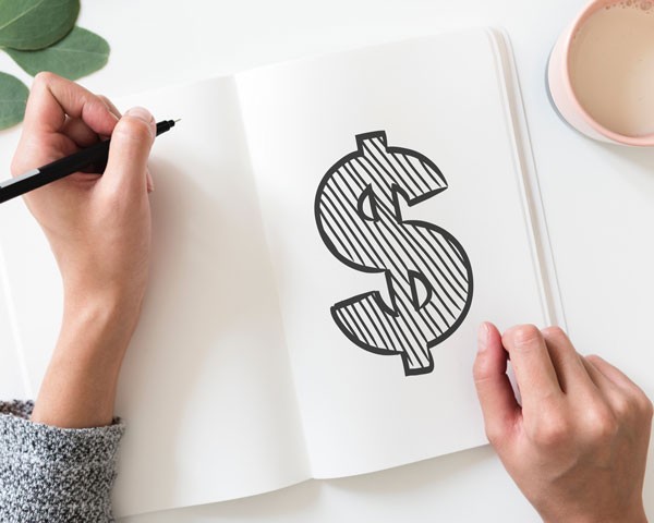 A notebook with a dollar sign on the page A notebook with a dollar sign on the page