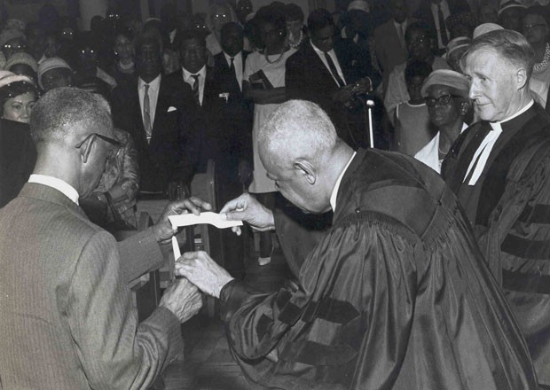 Reverend Charles Este was minister of the Union United Church for 45 years (1923-45). Here he is ceremonially burning the church's mortgage. 