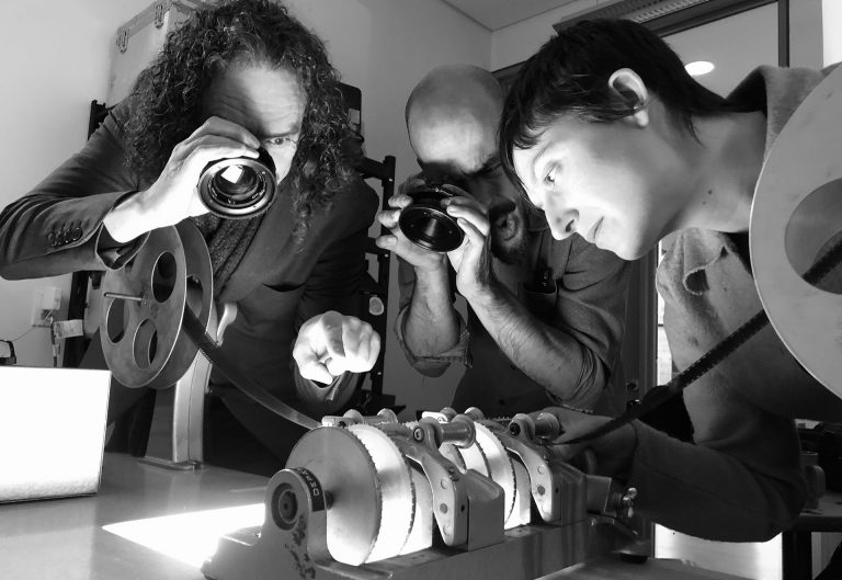 Devotees of emulsion Roy Cross, Kevin Teixeira and Erin Weisgerber undertake close inspection of film processed in instant coffee. | Photo by Daisy Woodhams	