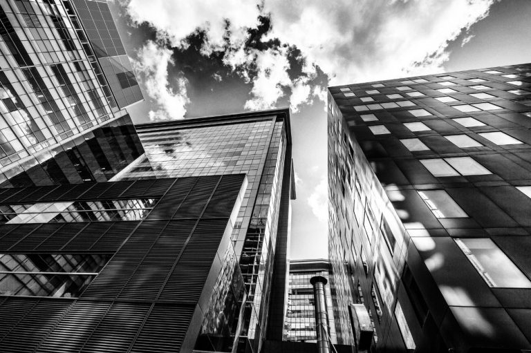 An abstract, black and white picture featuring buildings and the sky.