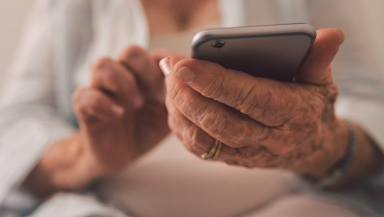 Close up of an older woman using a smartphone