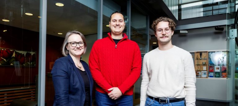 Marta Kersten-Oertel wears glasses and a blue blazer over a dark shirt, Anil Batmaz has a bright red sweater, Laurent Voisard a white sweater and blue jeans