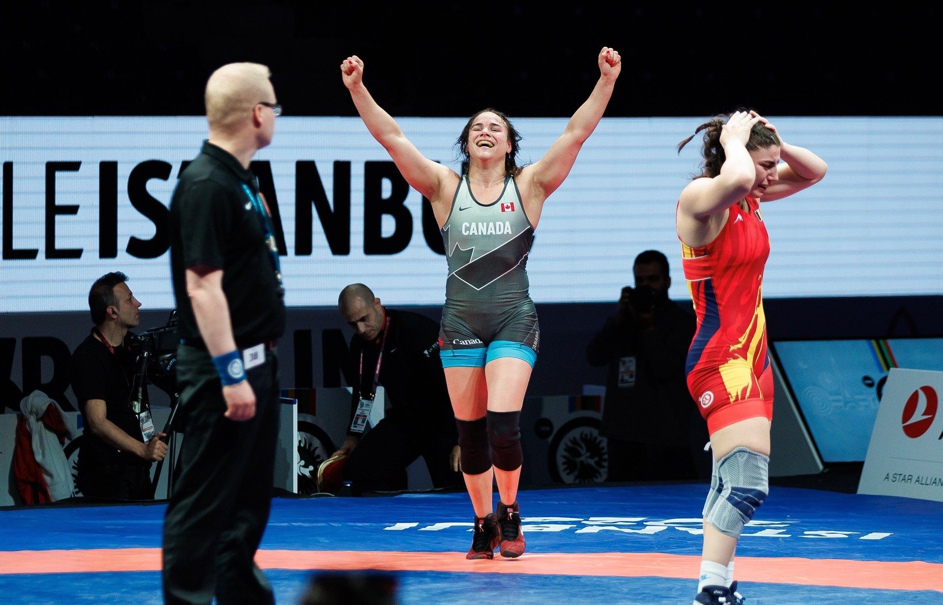 Linda Morais Linda Morais with her fists in the air celebrating a win.