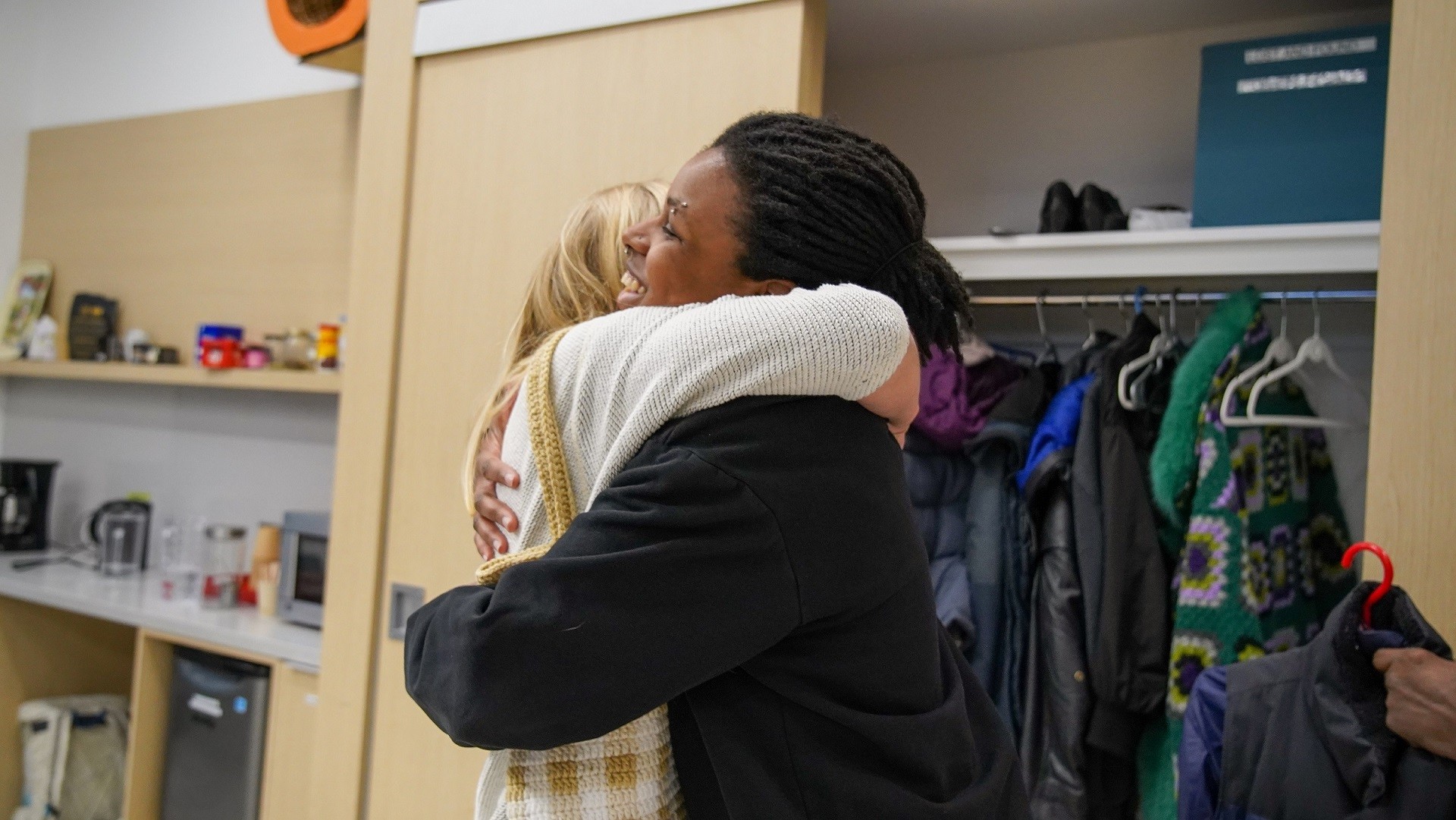 Two people hugging in the SHIFT Centre Two people hugging in the SHIFT Centre