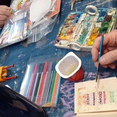 People drawing and painting on a table
