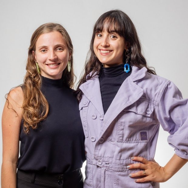 A photograph of two individuals smiling.