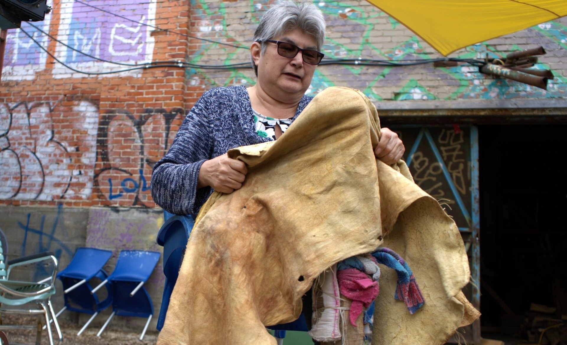 Kitigan Zibi guest holds buckskin hide