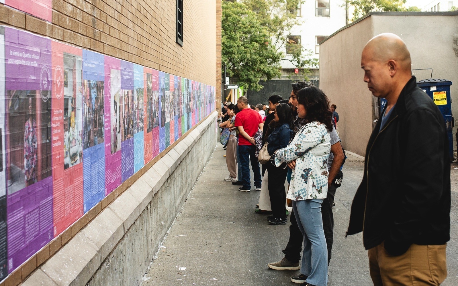People looking at a public storytelling exhibition Made in Chinatown
