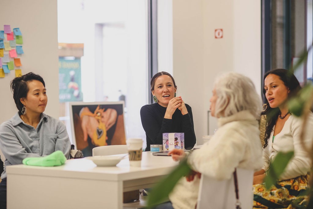 4 people sitting a table in the SHIFT co-working space