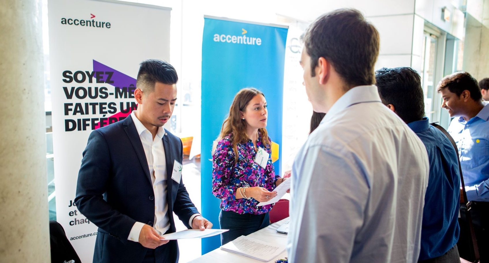 An employer meeting students at a Concordia career fair