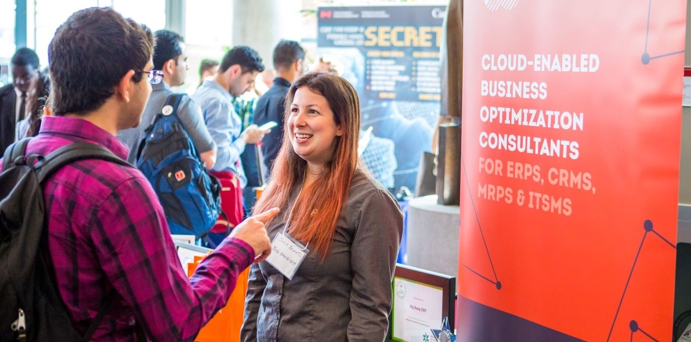 An employer meeting students at a Concordia career fair