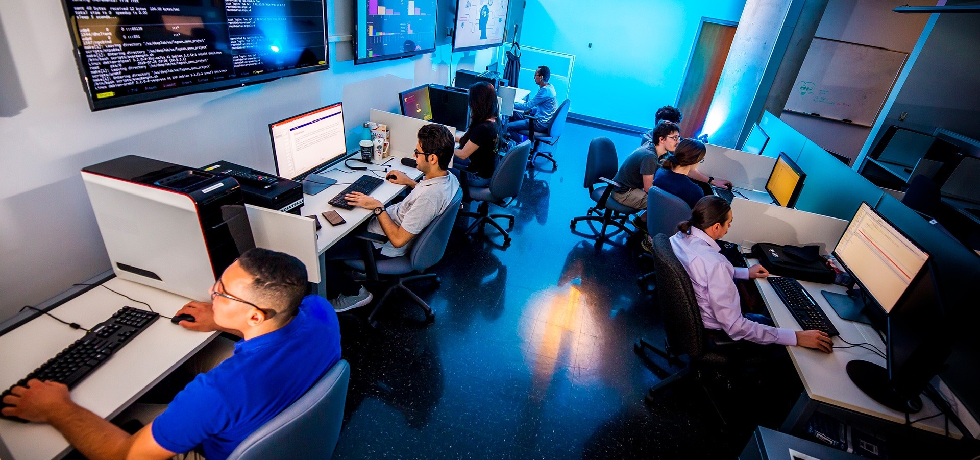 Cybersecurity analysts working in a computer lab
