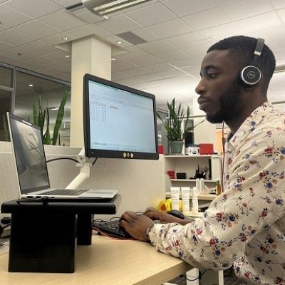 Student working at computer wearing headset