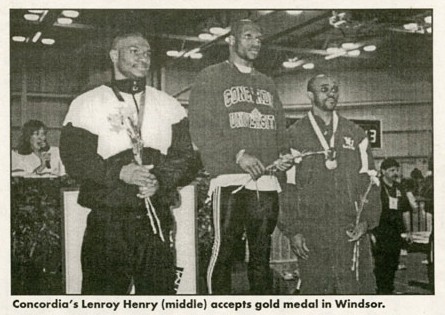 Lenroy Henry (centre) accepts gold medal in Windsor.