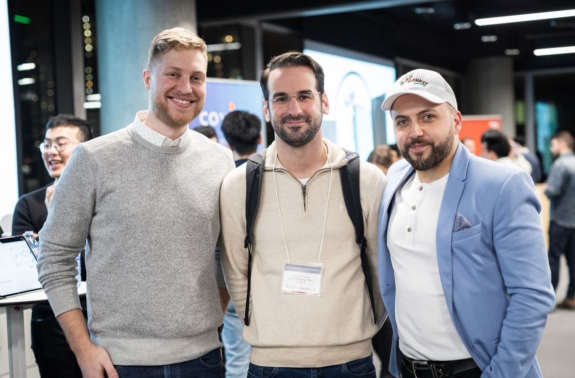 3 young men who are all John Molson School students stand and smile at a Career Fair