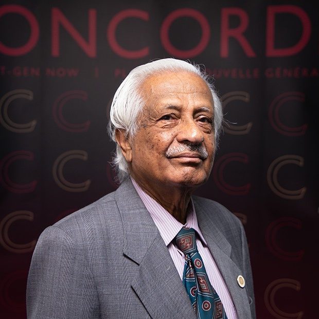 A man in a suit and tie. He smiles at the camera