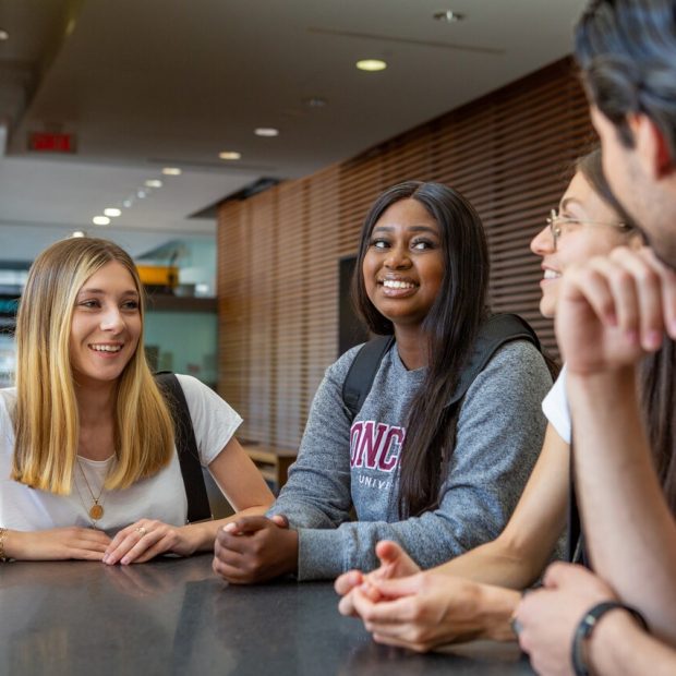 Image of four Concordia University students talking to each other