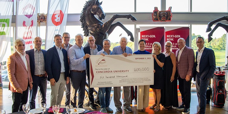 Alumni and donors hold up a big cheque to show the funds raised at the Golf Classic