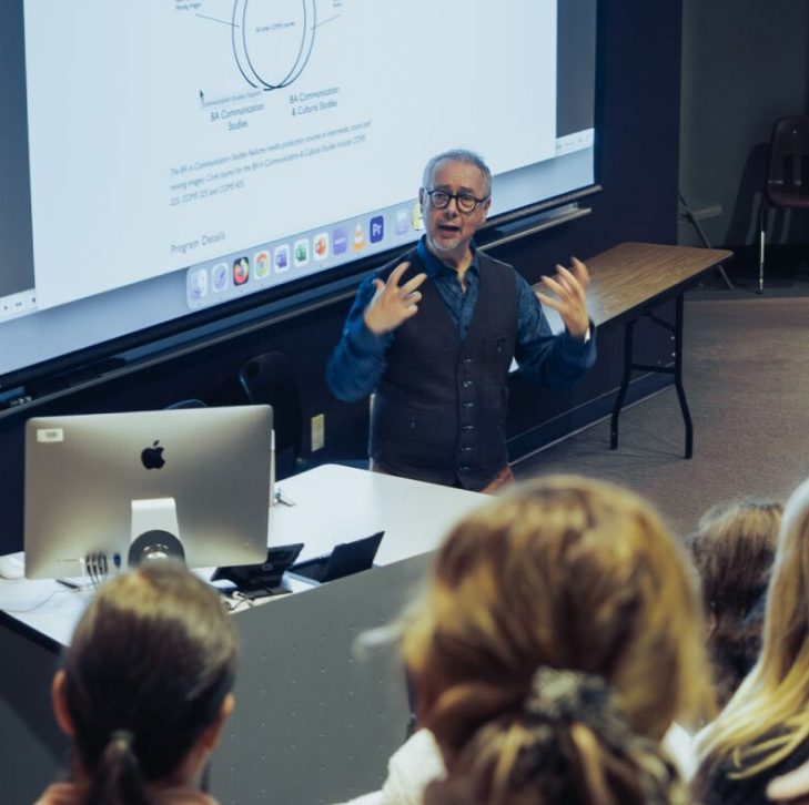 A professor is teaching a communications class in an auditorium at Concordia University