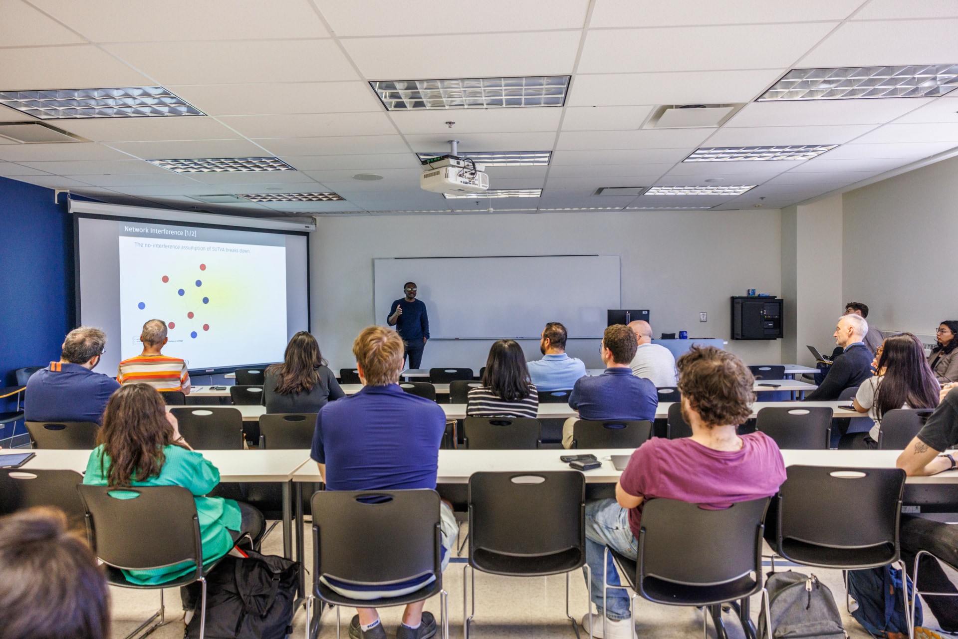 A photo of an Economics seminar with Dr. Julius Owusu presenting